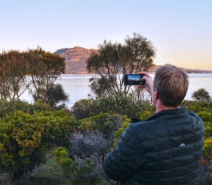 Careers. Taking photo of mountains at Edge of the Bay