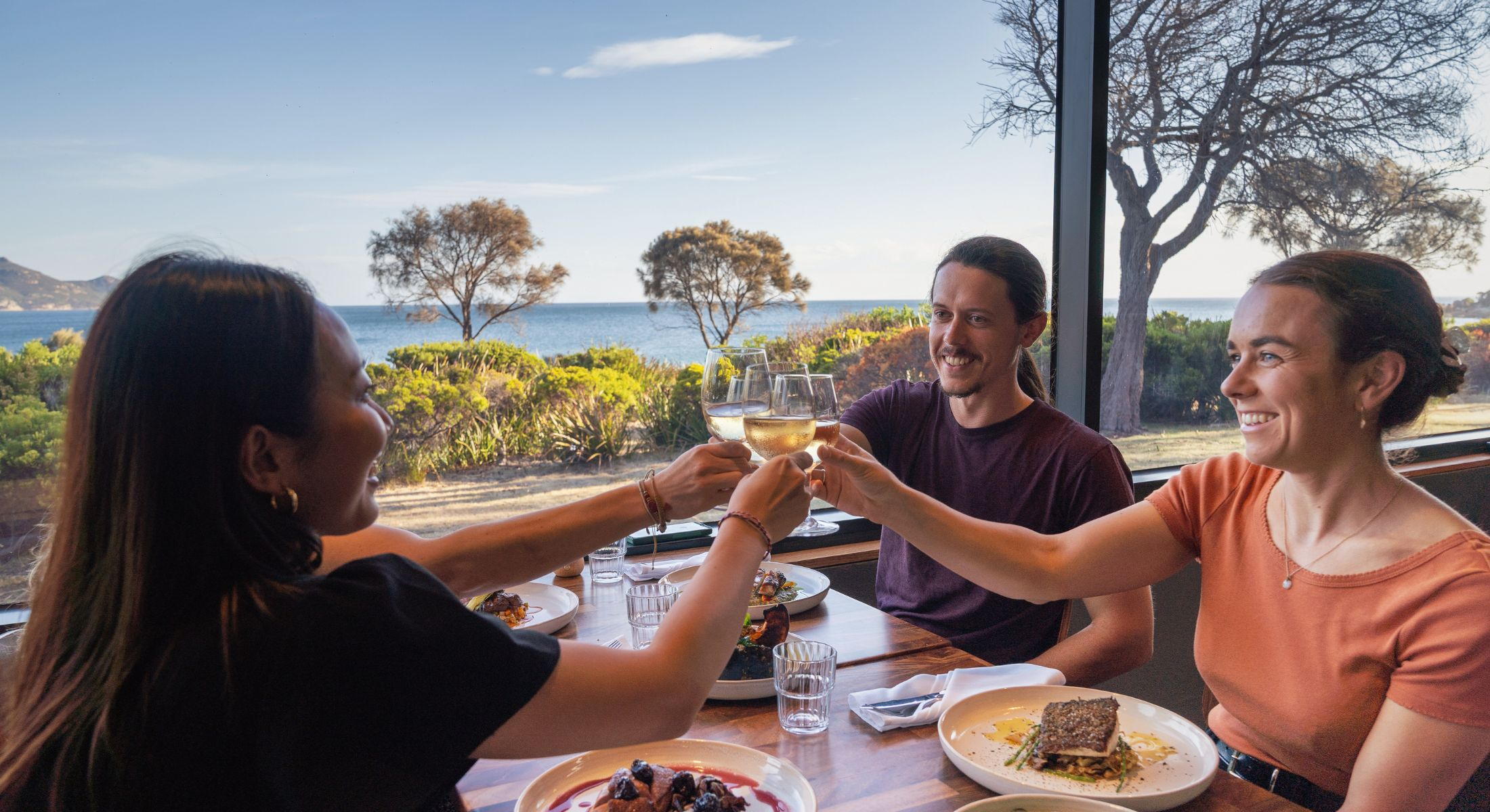 The Edge Restaurant group dining and saying cheers with wine