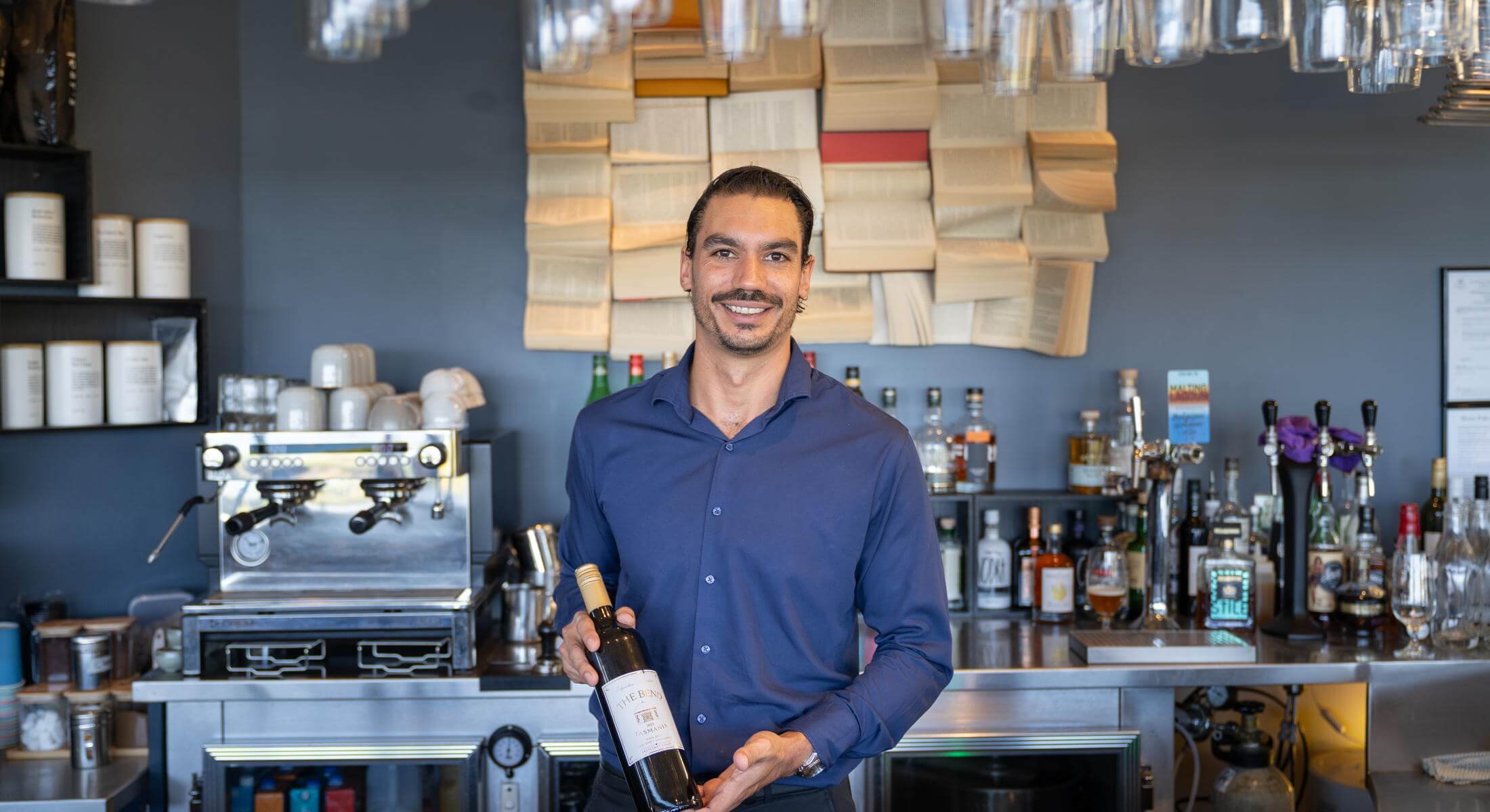 The Edge Bar with the barman offering a bottle of wine